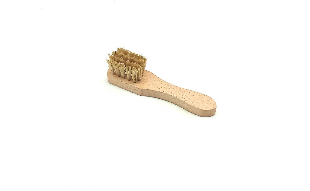 Shoe brush with bristles and a wooden handle